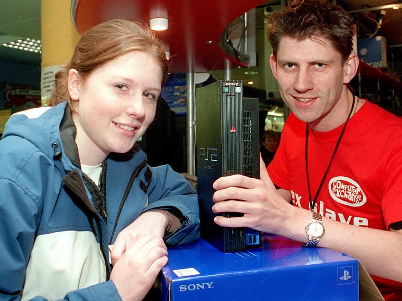A Playstation 2 was one of the 'must have' Christmas presents. Pictured is Catherine Taylor snapping a console up for her boyfriend at the Computer Exchange. She is served by sales assistant Angus Cunningham.