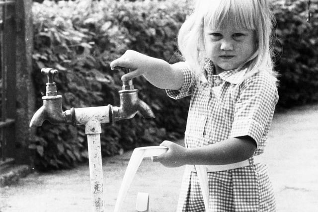 Julie Greensmith at a standpipe test outside her home on Fir Tree Green at Moortown during the drought of 1976.