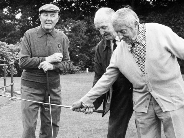 Henry Cotton, right, gives Joe Gent a few tips on how to improve his game with some tyre exercises on the first tee at Moortown in July 1979. He is watched by the former British Amateur champion Alex Kyle.