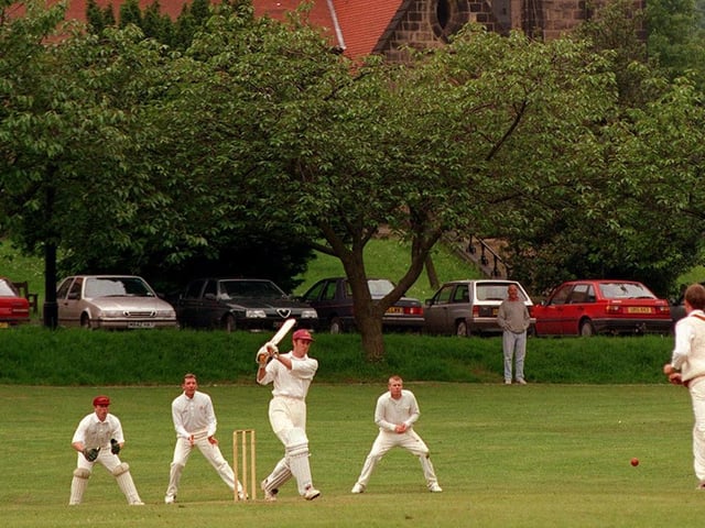 Batter Phil Borrow faces St Chad's bowler Daniel Carboon against the backdrop of St Chad's Church in Headingley.
