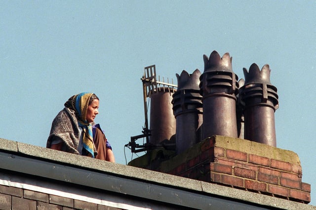 Roof top protest: This is Shakia Begum sat on her neighbours dormer roof after council officials tried to evict her from her Burley home.