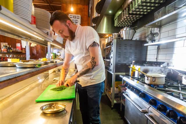 ack Richards, head chef at Zucco Italian restaurant, Meanwood Road, preparing his dish English Asparagus Peas's & Lemon Ristotto. Photo: James Hardisty
