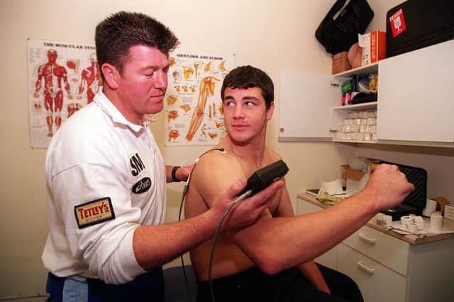Seamus McCallion pictured treating then-Rhinos player Adrian Morley in 1998. Picture by Charles Knight.