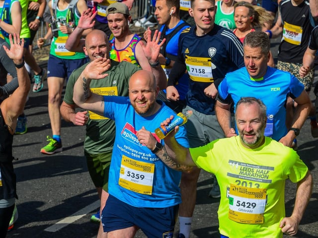 Runners wave to the camera.