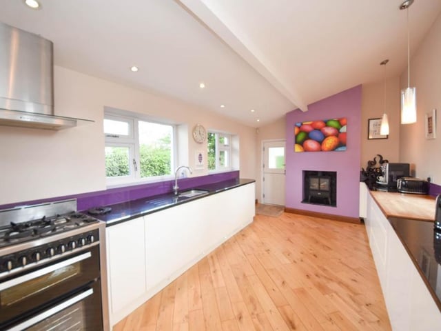 The sleek kitchen has plenty of natural light from its double windows.