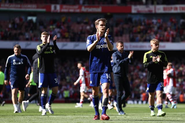 TOO LITTLE TOO LATE: Diego Llorente, front, pictured applauding the visiting Leeds United fans at Arsenal, pulled a goal back for the Whites but the damage was done in a disastrous first-half. Photo by Ryan Pierse/Getty Images.