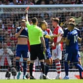 FLASHPOINT: Referee Chris Kavanagh dishes out a straight red card to Leeds United's Luke Ayling, third from left, as Kalvin Phillips and Diego Llorente hold back a furious Raphinha, right. Photo by GLYN KIRK/AFP via Getty Images.