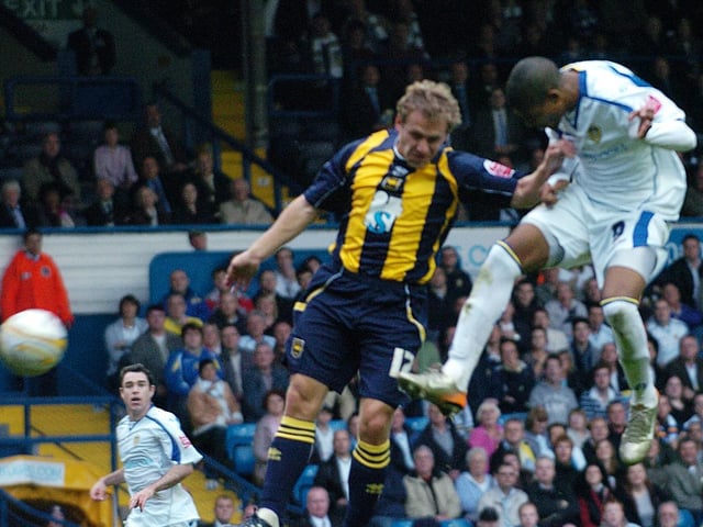Striker Jermaine Beckford rises high to open the scoring.