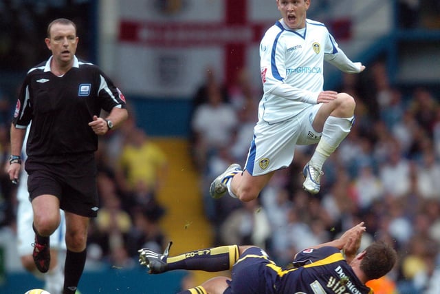 Neil Kilkenny jumps over a challenge by Brighton's Adam Virgo.