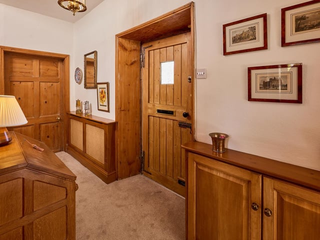 Large wooden doors are a feature in themselves within this home.