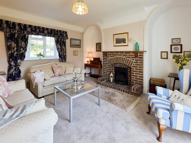 The lounge has a feature brick fireplace as a centrepiece.