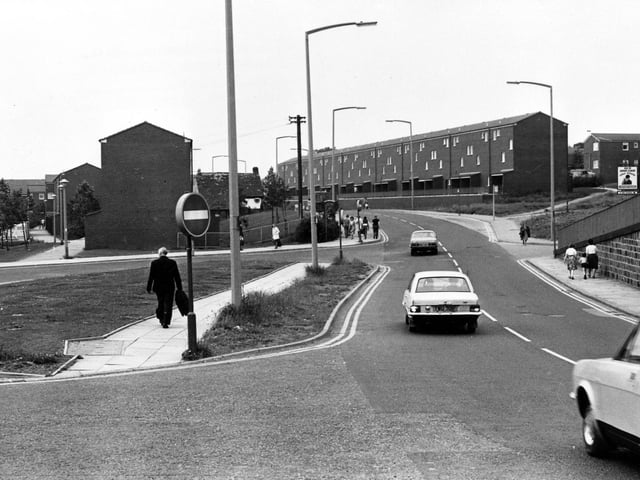 Lower Town Street showing a bus lay-by on the left. On the right is the sign for the Old Unicorn public house, just off the picture.