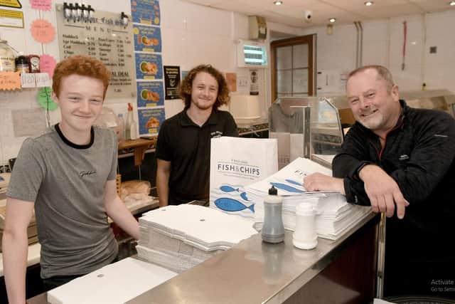 Mark Savage with his sons Oliver and Joseph, owns The Village Fish Shop in Shadwell. Picture: Gary Longbottom.