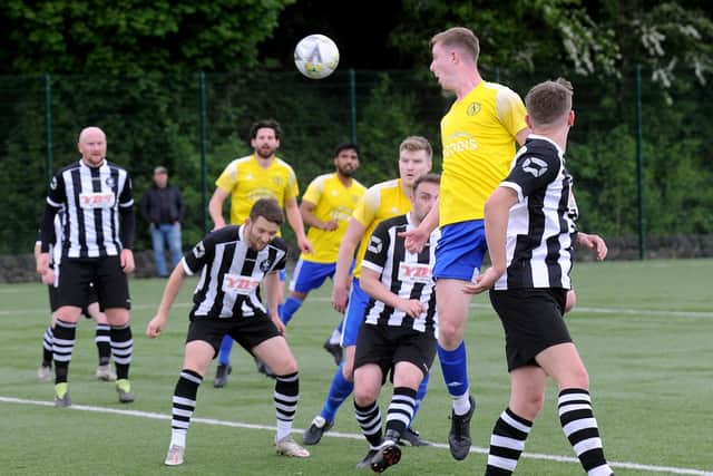 Archie McDonnell, of HorsforthSt Margarets, heads on in the 2-0 win over Hall Green United. Picture: Steve Riding.