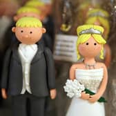 Wedding cake bride and groom figures are displayed for sale on July 10, 2007 in London. (Photo by Peter Macdiarmid/Getty Images)