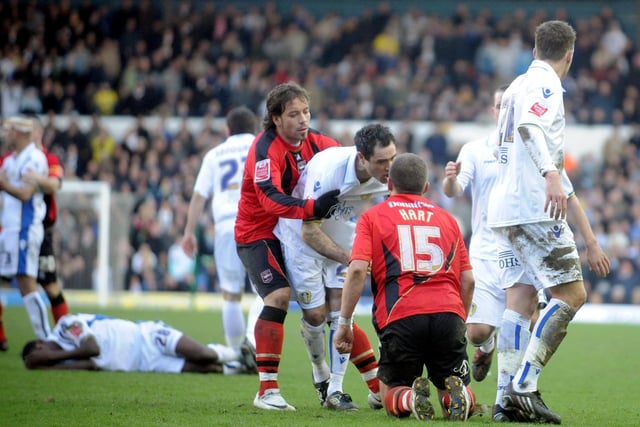Andrew Hughes is pulled back by Brighton's Inigo Calderon, whilst trying to confront Brighton's Gary Hart, following a challenge on teammate Max Gradel at Elland Road in February 2010.