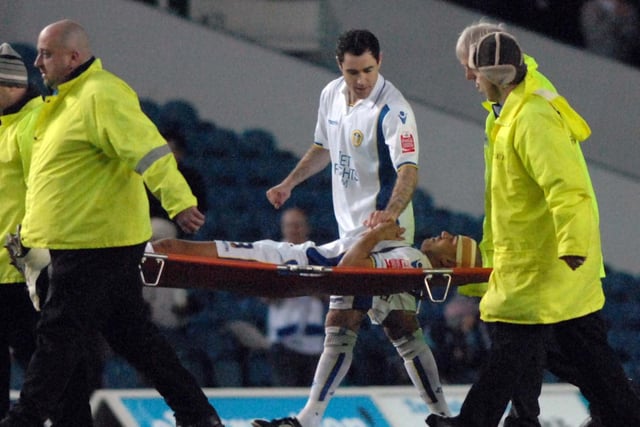 Andrew Hughes speaks to Patrick Kisnorbo as he is carried off during Leeds United's clash with Millwall at Elland Road in March 2010.