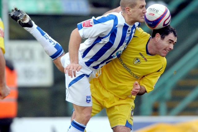 Andrew Hughes clashes with Brighton's Adam El-Abd during the League One clash at the Withdean Stadium in January 2009.