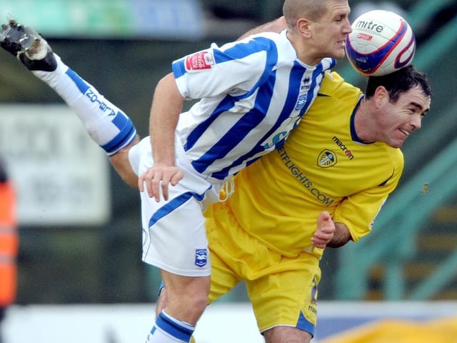 Andrew Hughes clashes with Brighton's Adam El-Abd during the League One clash at the Withdean Stadium in January 2009.