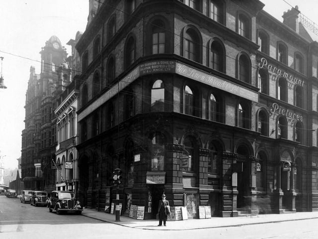 A man with a fob watch and suitcase is pictured on the corner of Wellington Street and King Street in June 1939.Behind him is a shop F J Williams, tobacconist with newspaper headlines, advertisements.