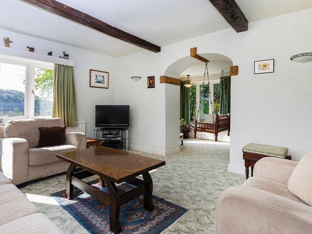 The comfortable interior is filled with natural light from windows that showcase the far-reaching views.