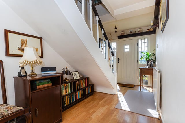 An open plan staircase to the first floor, and under stairs space that currently hosts a bookcase.
