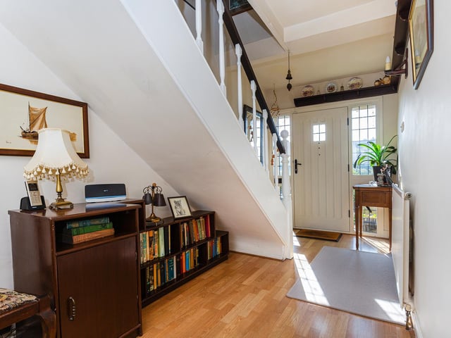 An open plan staircase to the first floor, and under stairs space that currently hosts a bookcase.