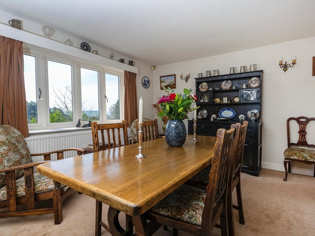 A room that can accommodate a large table and chairs, and that has plenty of natural light from its sizeable windows.