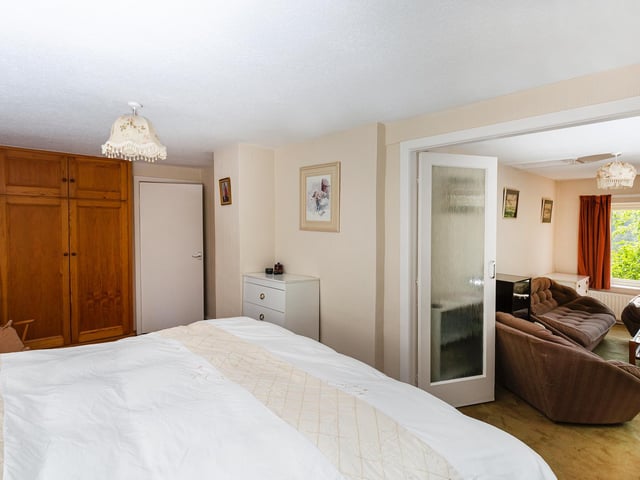 This bedroom flows through to an adaptable and useful side facility.