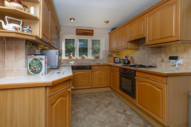 Integrated appliances within the kitchen include an oven, hob, and dishwasher.