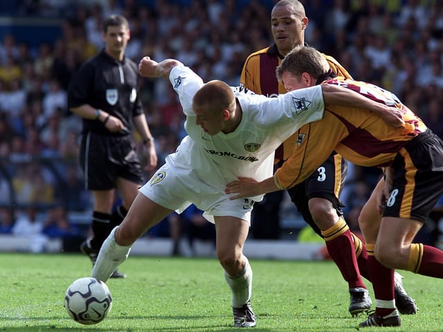 Alan Smith holds off Bradford City's Gunnar Halle.