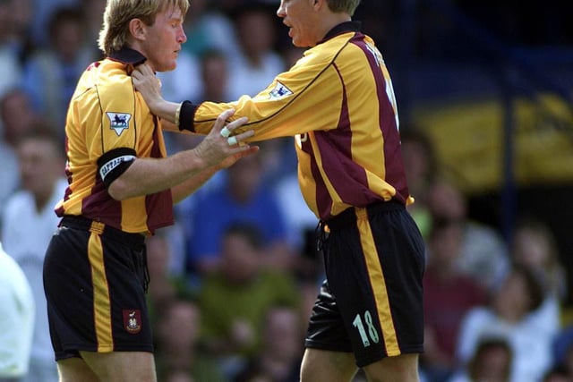 Bradford City captain Stuart McCall is held back by teammate Gunnar Halle during an incident with Andy Myers.