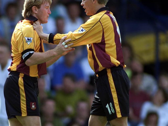 Bradford City captain Stuart McCall is held back by teammate Gunnar Halle during an incident with Andy Myers.