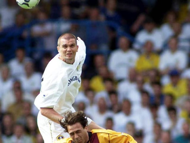 Dominic Matteo rises high to head the ball clear under pressure from Bradford City's Ashley Ward