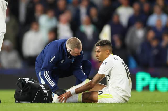 ASSESS: Raphinha receives treatment on the turf at Elland Road (Photo by Robbie Jay Barratt - AMA/Getty Images)