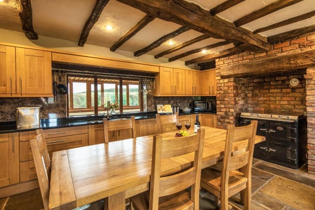 This hub features a Yorkshire stone floor, a beamed ceiling and an inglenook fireplace with inset Everhot stove.​