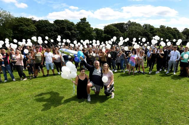 Steve, centre, along with George's sisters Rebecca and Charlotte, with family and friends at an event in 2020 to celebrate George's life.
