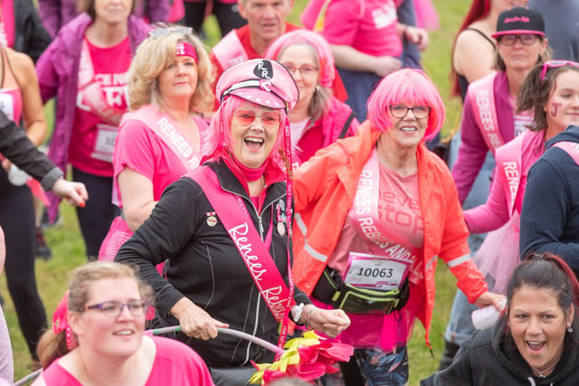 Many of the runners wore bright pink sashes, tutus, hats or wigs.