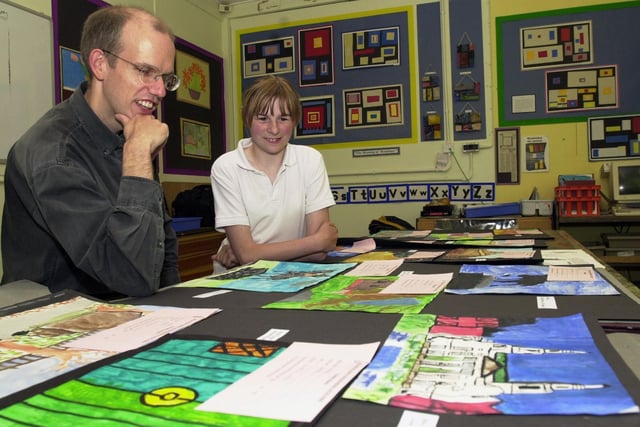 Artist Clifford Stead with Stacey Hemmings, a pupil at Elmete Wood School looking through some of the paintings done by pupils which were being considered for a 2001 calendar 'Millennium Leeds'