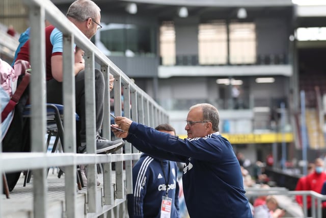 Then-manager Marcelo Bielsa signs autographs for supporters at Turf Moor before the Whites' 1-1 draw with Burnley (Photo by Jan Kruger/Getty Images)