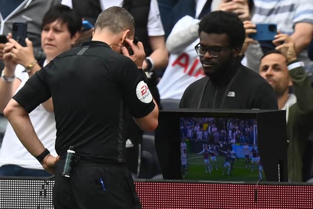 VAR: Referee Kevin Friend consults the pitchside monitor (Photo by GLYN KIRK/AFP via Getty Images)