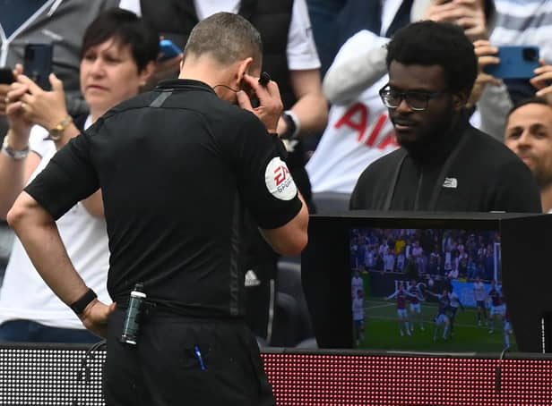 VAR: Referee Kevin Friend consults the pitchside monitor (Photo by GLYN KIRK/AFP via Getty Images)