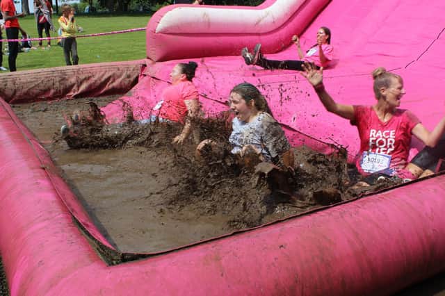 Fundraisers tackle the Pretty Muddy course at Temple Newsam Park.
