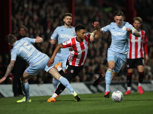 Brentford's Ollie Watkins is fouled by Stuart Dallas and Ben White.