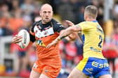 Liam Watts fends off Ben Crooks during Tigers' win over Hull KR. Picture by Will Palmer/SWpix.com.