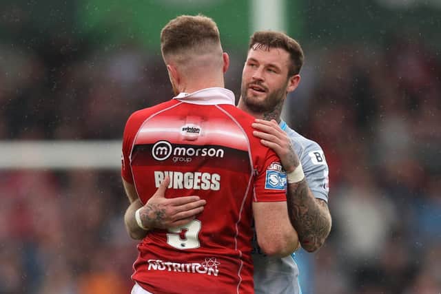 Leeds Rhinos' Zak Hardaker and Salford Red Devils' Joe Burgess embrace at the end of the match on Sunday. Picture: John Clifton/SWpix.com.