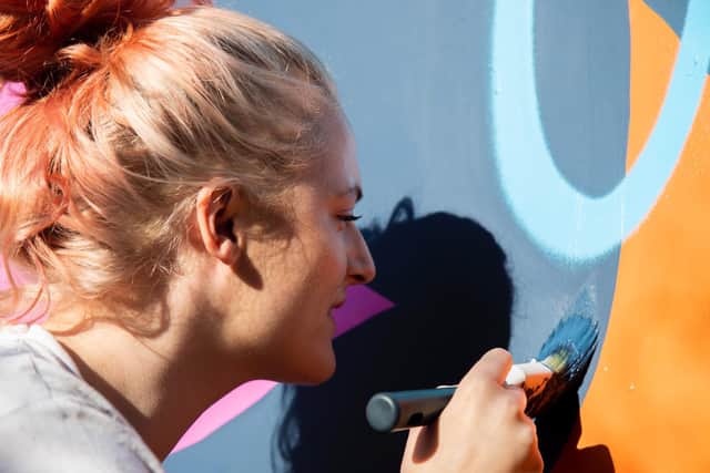 Mural artist Melody Sutherland has launched a new project at Merrion Gardens to tell the stories of women and people of marginalised genders. Pictured: Melody Sutherland. Photo: Laura Jones