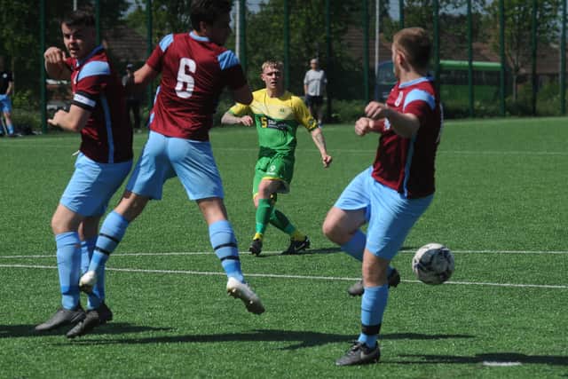 Richard Collier, of Middleton, looks on as his freekick is blocked by the Littletown wall. Picture: Steve Riding.