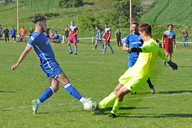 Horbury Town's Tom Schofield goes toe to toe with Rawdon OB goalkeeper Kamen Greaves. Picture: Steve Riding.