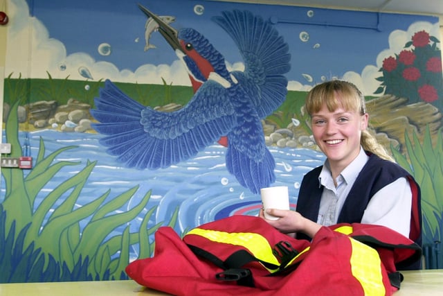 Postie Charlotte Green enjoy a brew by the mural she painted in the canteen at Hunslet Delivery Office.